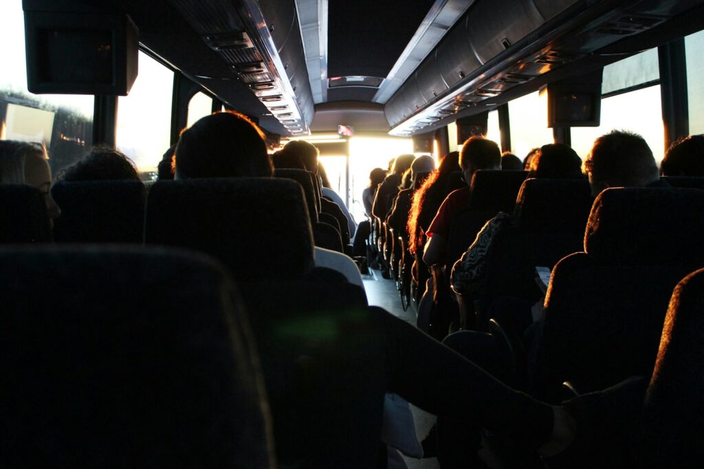 people riding passenger bus during daytime