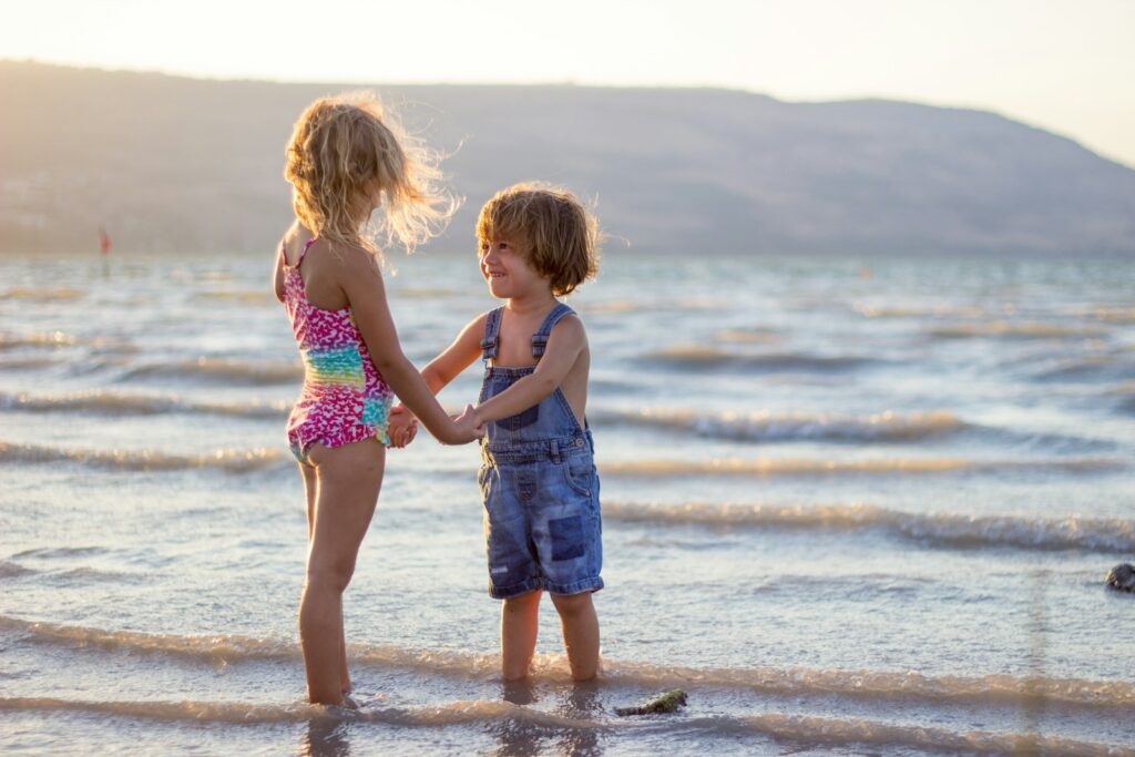 two girls standing on seashore on April break