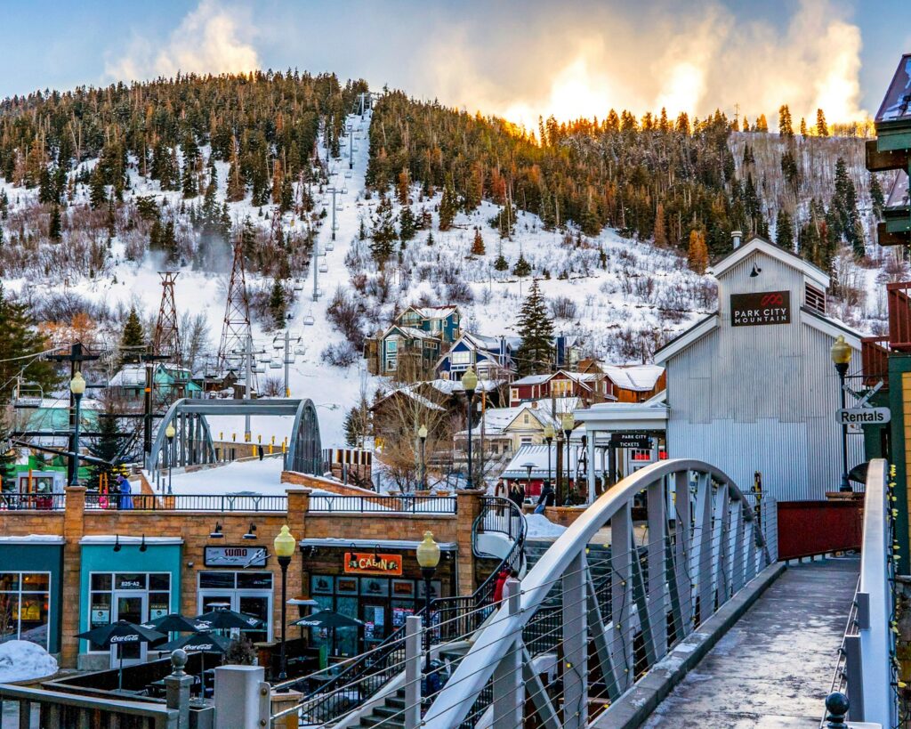 white wooden bridge over snow covered mountain during daytime in Park City Utah 